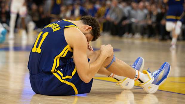 Warriors’ Klay Thompson sits on the floor.